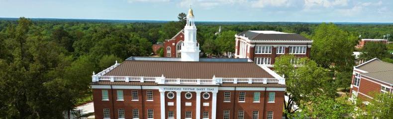 A drone image of a brick academic building at East Texas Baptist University